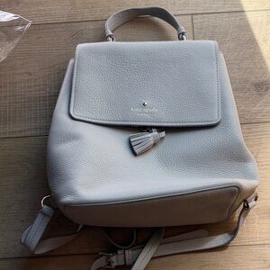 kate spade pebble leather backpack in pale gray with tassel